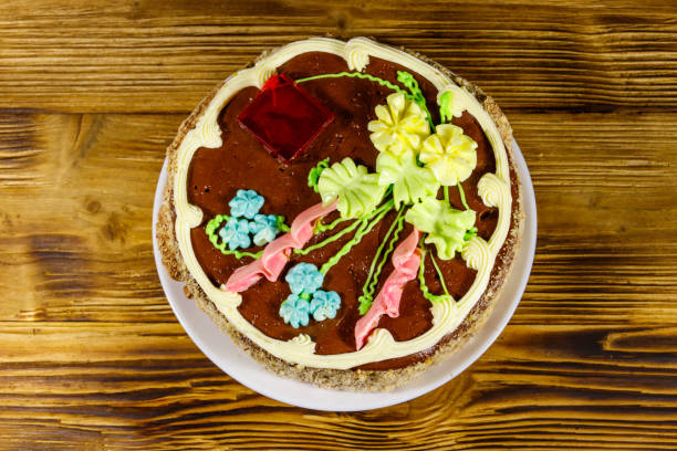 istock Kiev cake with cream, nuts and meringue on wooden table. Top view 1267508313