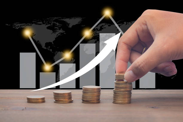 istock saving money hand putting coins on a stack with graph and arrow up 1267508513