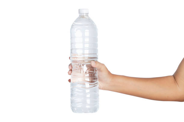 istock Hand holding water bottle isolated on white background. 1267508541