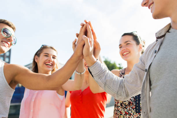 istock close up of happy friends making high five gesture 1267508732