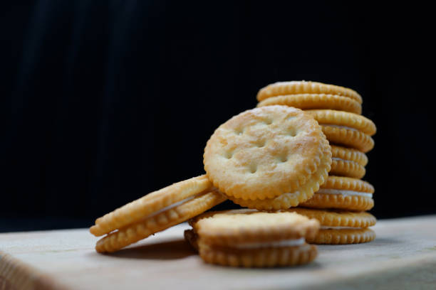 istock Close-Up Of Biscuits On Wooden Board, Black Background 1267511744