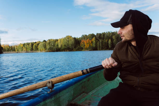 istock A man rowing on oars on an autumn lake 1267513393