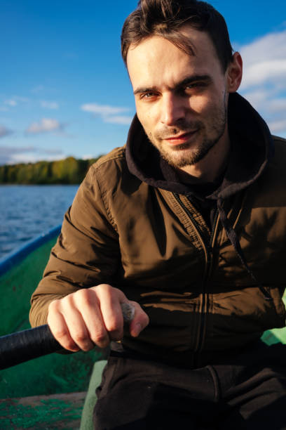 istock A man rowing on oars on an autumn lake 1267513443