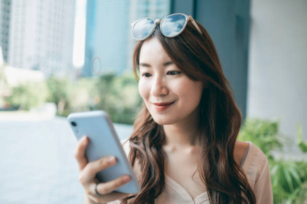 istock Young Woman Sitting In Cafe Using Smartphone 1267514437