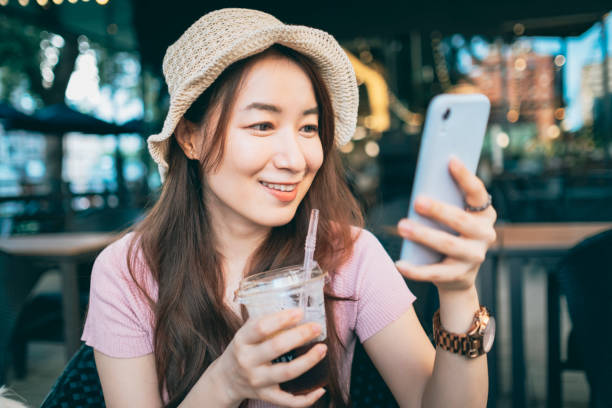 istock Young Woman Sitting In Cafe Using Smartphone 1267514460
