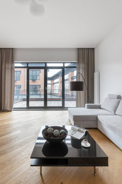 istock Spacious living room with big windows 1267515433