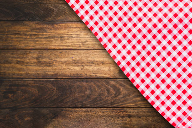 istock Red checkered table cloth on dark wooden table. 1267517974