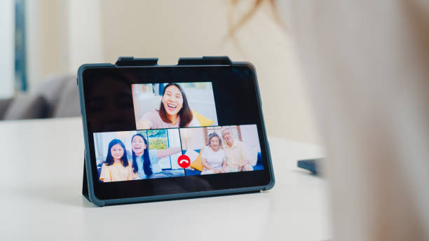 young asian business female using tablet video call talking with family while working from home at living room. - father digital tablet asian ethnicity daughter imagens e fotografias de stock