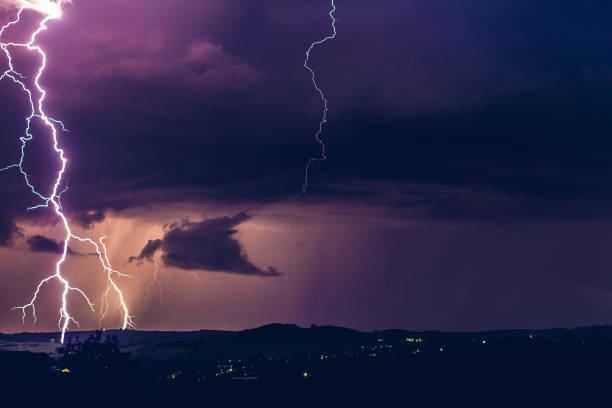 istock Night landscape on a background of thunderstorms. Rural silhouette and clouds with lightning flashes 1267519412