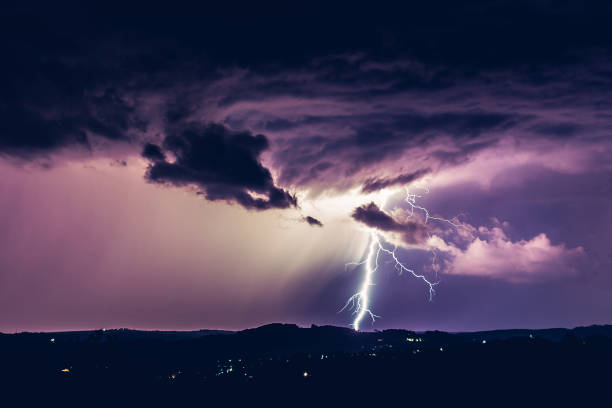istock Night landscape on a background of thunderstorms. Rural silhouette and clouds with lightning flashes 1267519432