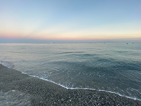 Minimalistic landscape of sea in sunset with natural gradient on sky