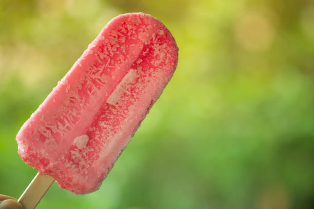 istock Tasty and refreshing strawberry flavor popsicles on blur nature background 1267519621