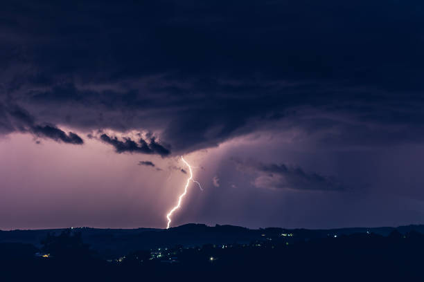istock Night landscape on a background of thunderstorms. Rural silhouette and clouds with lightning flashes 1267519624