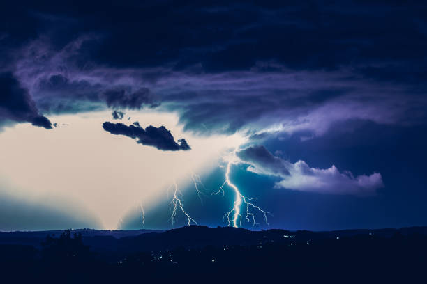 istock Night landscape on a background of thunderstorms. Rural silhouette and clouds with lightning flashes 1267519626