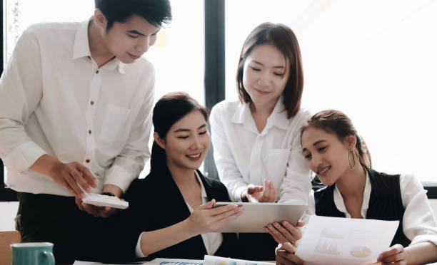 istock Asian business searching information for provide ideas in new startup project using touch pad during brainstorming, collaboration and cooperation.Four colleagues sharing opinions at meeting 1267520427