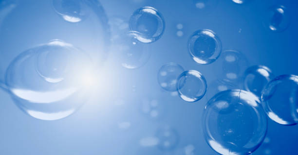 istock Bubbles Abstract Background. Group of Blue Soap Bubbles Float In The Dark. 1267520512
