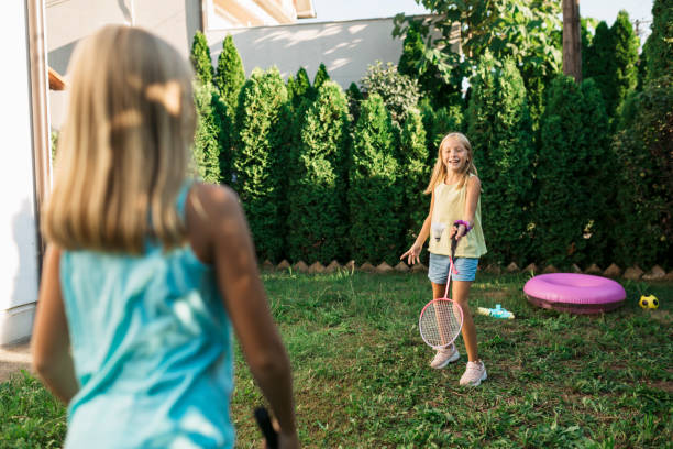 istock Two sisters playing badminton in their back yard 1267520652