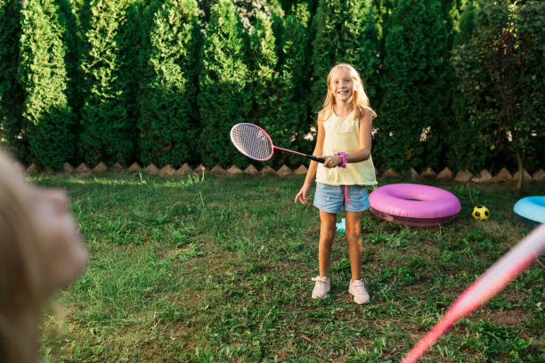 istock Two sisters playing badminton in their back yard 1267520674