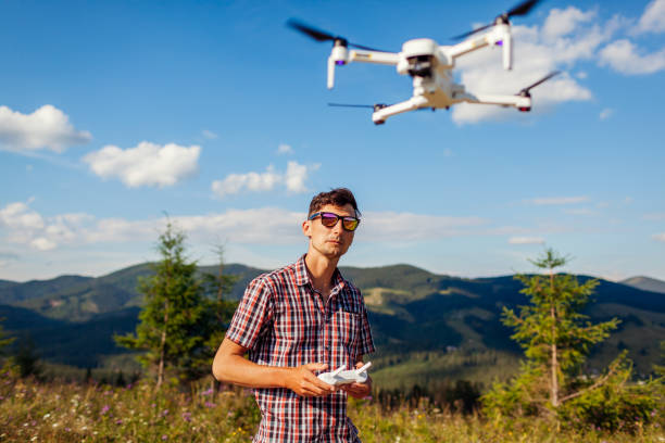 istock Man operating copter controller in mountains. Drone remote control. Aerial footage shooting of summer Carpathins 1267520968
