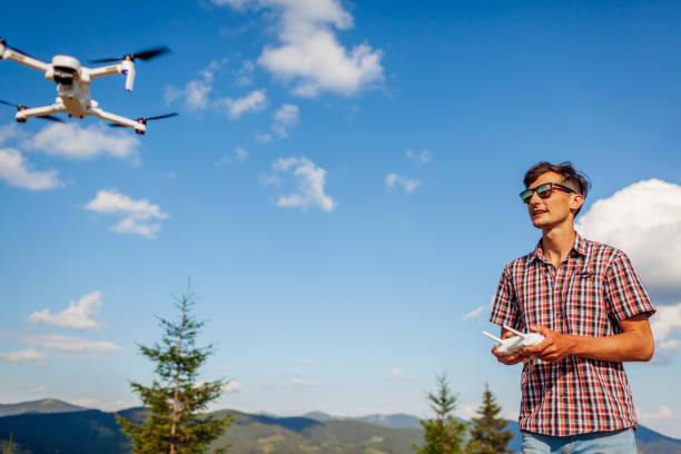 istock Aerial drone footage shooting of summer Carpathins. Man operating copter controller in mountains. Tourist filming nature 1267520981