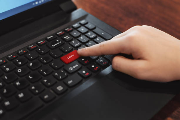 Red button 'Learn' on keyboard stock photo