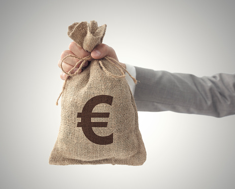 Money bag with Euro sign European Union currency business man holding outstretched