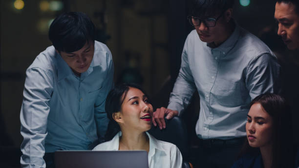 istock Businesspeople using laptop presentation and communication meeting brainstorming ideas about new project colleagues in night office. 1267526728
