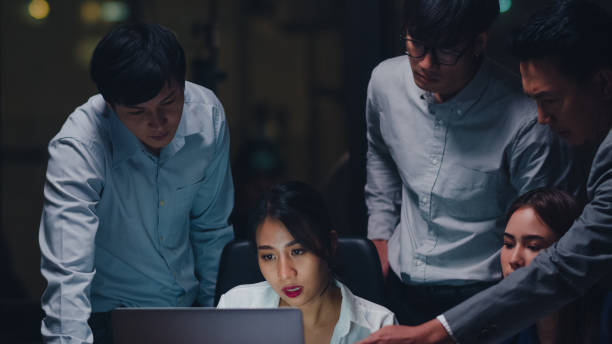 istock Businesspeople using laptop presentation and communication meeting brainstorming ideas about new project colleagues in night office. 1267526910