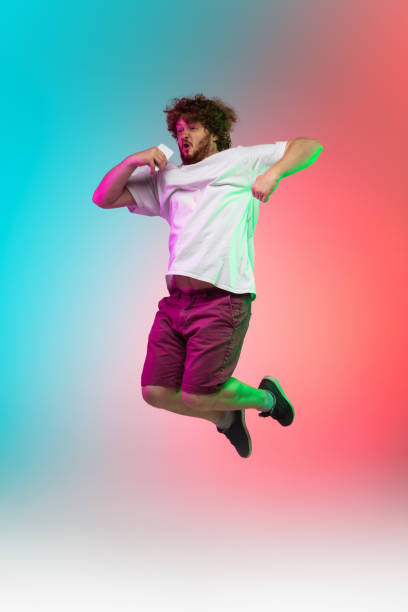 istock Caucasian young man's portrait on gradient studio background in neon 1267527336
