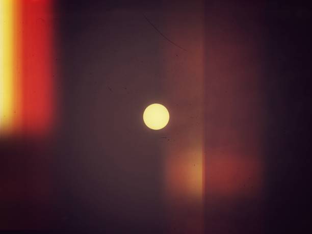 istock Yellow sphere brighten in dark vertical brown background 1267529443