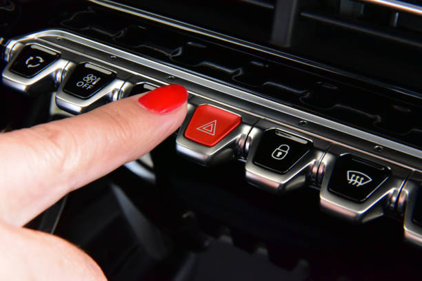istock Woman pressing red triangle car hazard warning button 1267531014