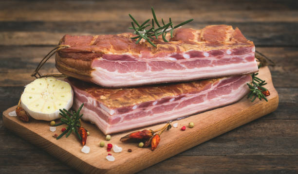 istock Fresh smoked bacon on wooden board 1267531098