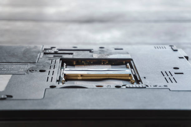 istock Repairman fixing and repair memory ram or setup hardware for the computer on laptop motherboard with his hands 1267531154