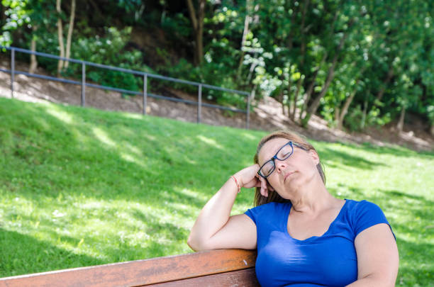 istock Woman resting on a bench in park 1267531771