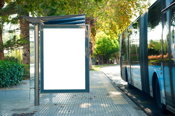 istock Blank electronic advertising poster with blank space screen for your text message or promotional content, clear banner in urban setting, empty poster at a bus stop, public information billboard 1267532484