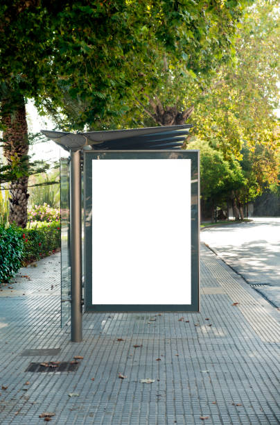 istock Blank electronic advertising poster with blank space screen for your text message or promotional content, clear banner in urban setting, empty poster at a bus stop, public information billboard 1267532499