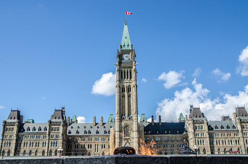 Centenary Flame and Parliament of Canada during summer day