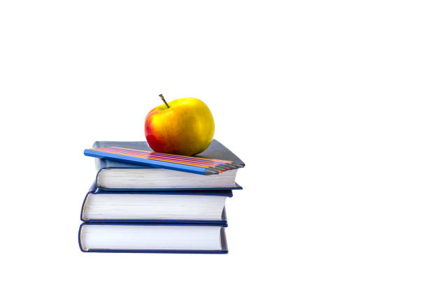 istock Education or back to school concept. An apple and multi-colored pencils on a stack of book 1267535531