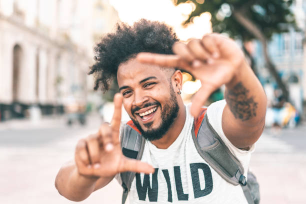 istock Laughing man making frame with hands outdoors 1267536640