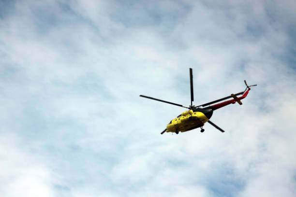 istock medevac helicopter flying in blue cloudy sky. Image contains copy space 1267536659
