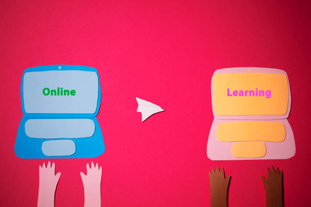 istock Two handmade laptops were cut out of colored paper on a red background 1267536877