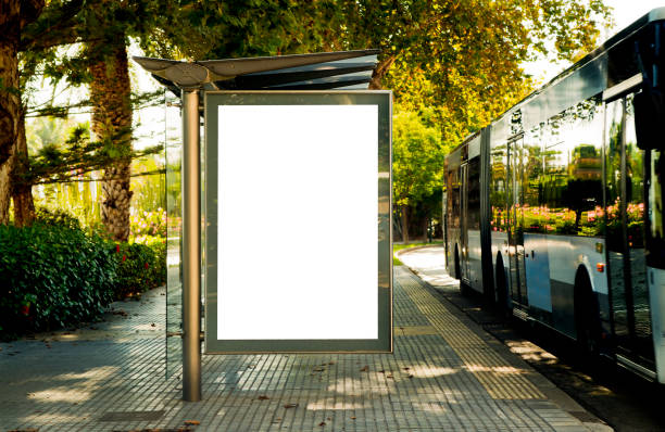 istock Blank electronic advertising poster with blank space screen for your text message or promotional content, clear banner in urban setting, empty poster at a bus stop, public information billboard 1267537513