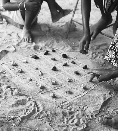 African game with charcoal and dirt