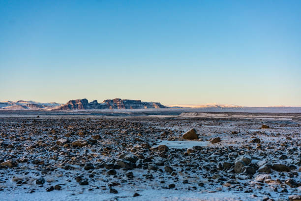 Winter landscape in Iceland with mountains and snow plains, shot at sunset.