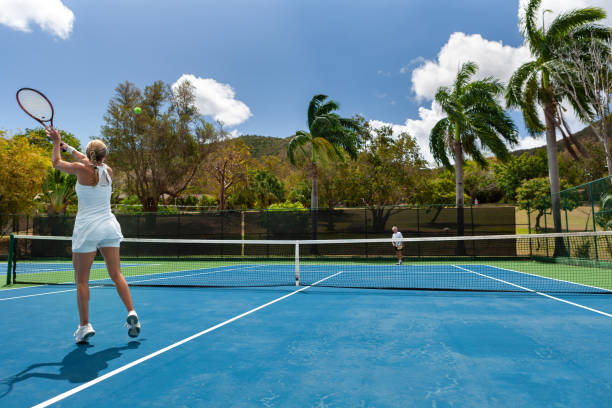 istock couple playing tennis in tropical climate 1267538162