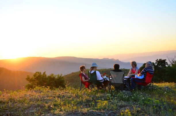 istock People sitting at the camping site at sunset 1267541187