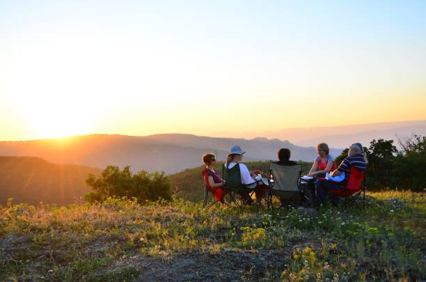 istock People sitting at the camping site at sunset 1267541192