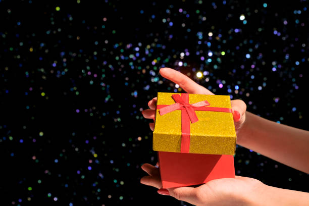 istock Female hand holding a gift box on a blurred background. 1267541380