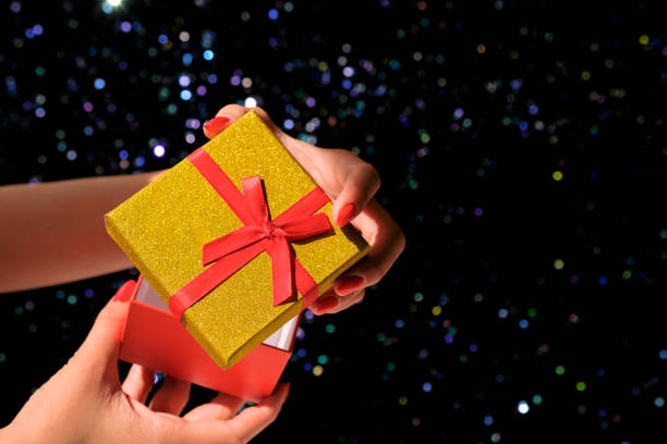 istock Female hand holding a gift box on a blurred background. 1267541398