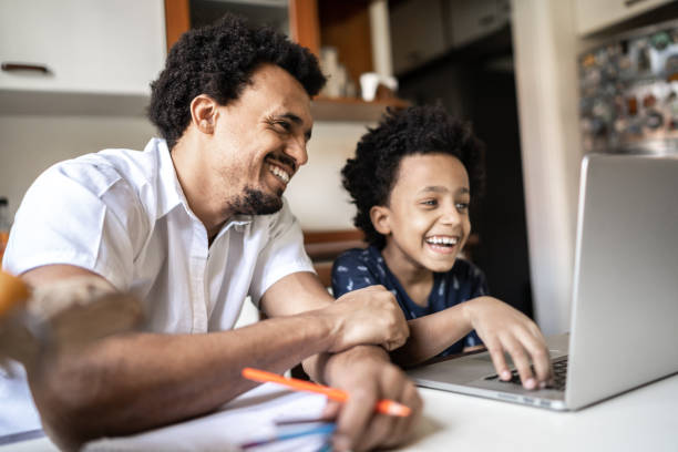 istock Father helping son during virtual class at home 1267542558